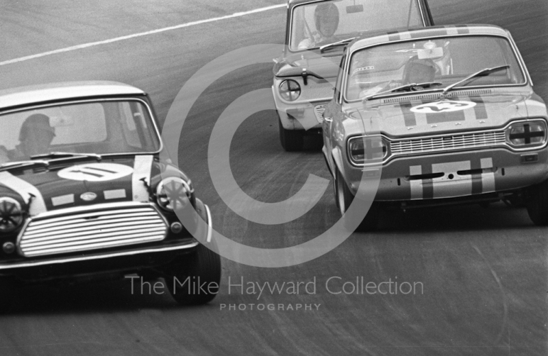 John Rhodes, Mini Cooper S, Alan Peer, Ford Escort GT, and Tony Lanfranchi, Alan Fraser Sunbeam Imp,&nbsp;at South Bank Bend, Brands Hatch, Grand Prix meeting 1968.

