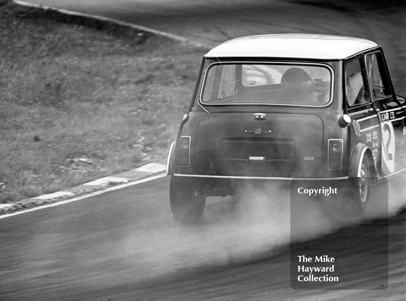 Steve Neal, Cooper Car Company Mini Cooper S, smokes around South Bank Bend, ritish Saloon Car Championship race, 1968 Grand Prix meeting, Brands Hatch.
