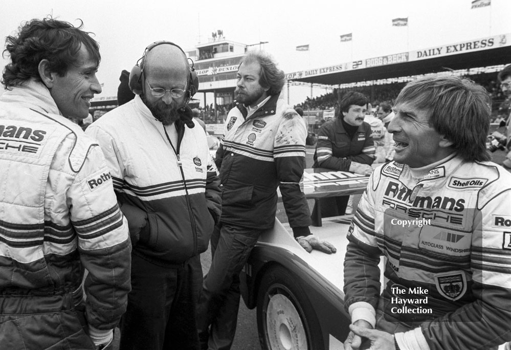 Rothmans Porsche drivers Derek Bell and Jacky Ickx on the grid, World Endurance Championship, 1985&nbsp;Grand Prix International 1000km meeting, Silverstone.
