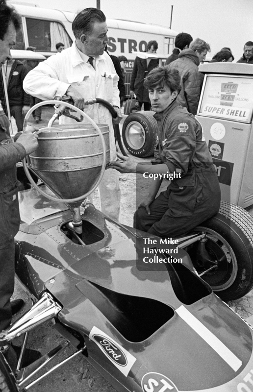 Gold Leaf Team Lotus mechanics fill up Graham Hill's Lotus Ford 49B at the paddock pumps, Silverstone, International Trophy 1969.