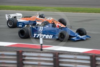 Bill Coombs, Tyrrell 009, and Steve Hartley, Arrows A4, at Woodcote Corner, F1 Grand Prix Masters, Silverstone Classic, 2010
