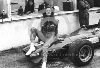 A model poses on the Ferrari V12 312 0011 of Chris Amon in the pit lane during practice, British Grand Prix, Brands Hatch, 1968.
