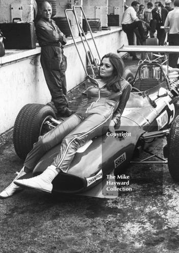 A model poses on the Ferrari 312 V12 of Chris Amon in the pit lane during practice, British Grand Prix, Brands Hatch, 1968
